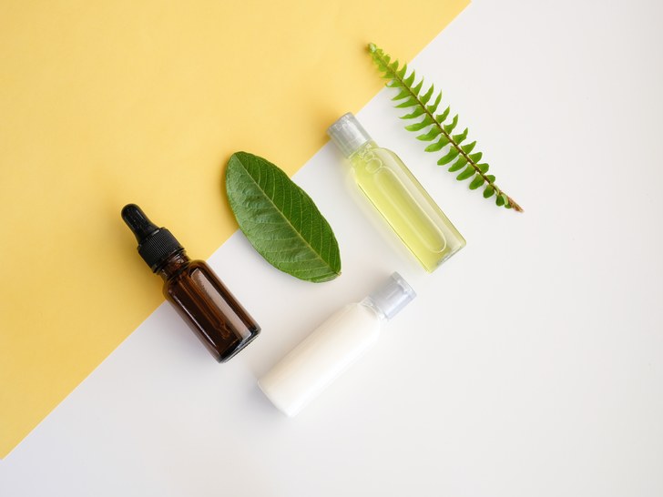 Bottles of skin-care oils with leaves.