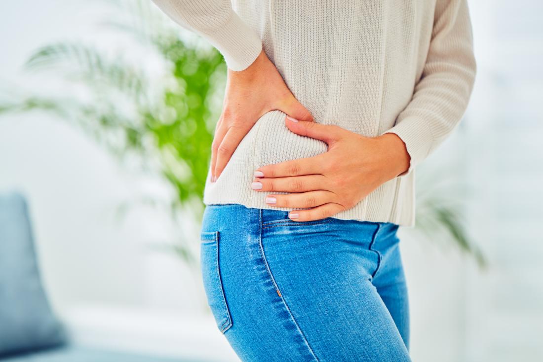 Woman holding her hip in pain