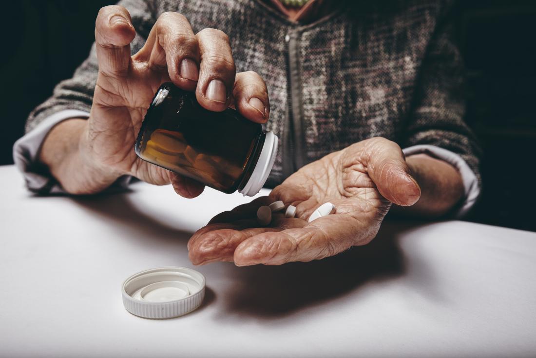 Older adult taking pills