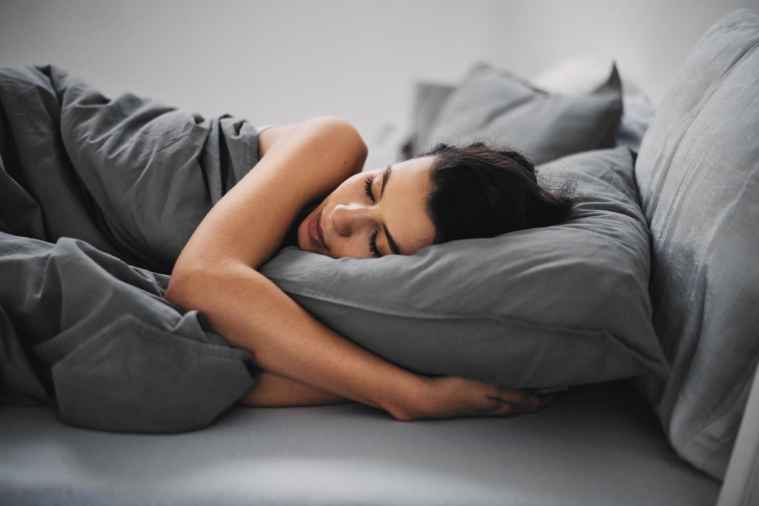 Woman sleeping in her bed