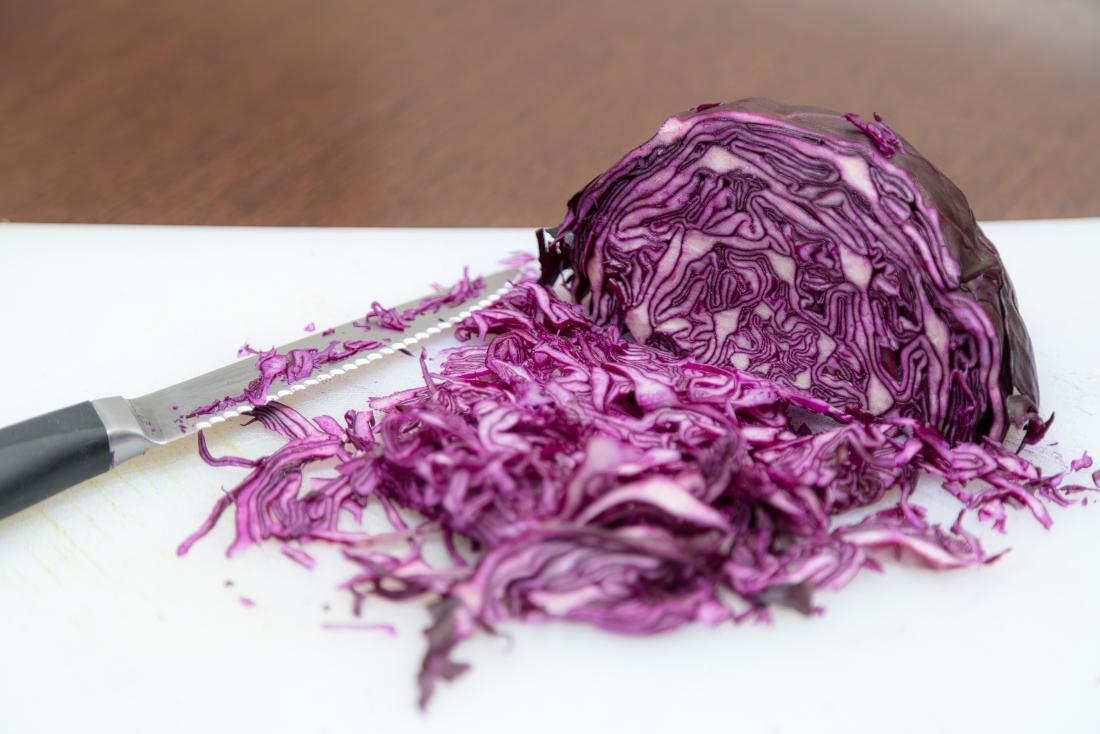 chopped red cabbage on a chopping board. 
