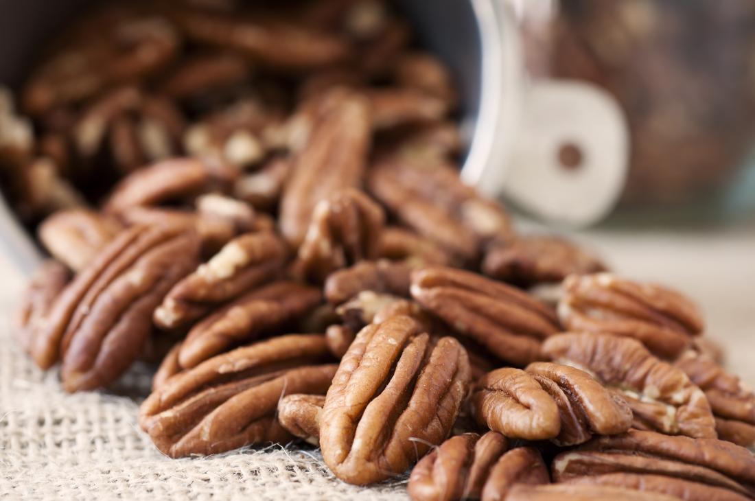 Pecan Halves Tumbling out of a Measuring Cup