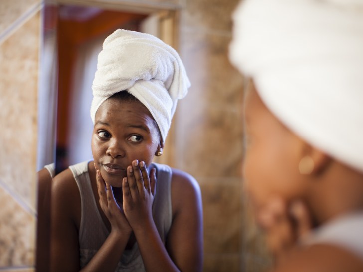 woman looking at herself in the mirror