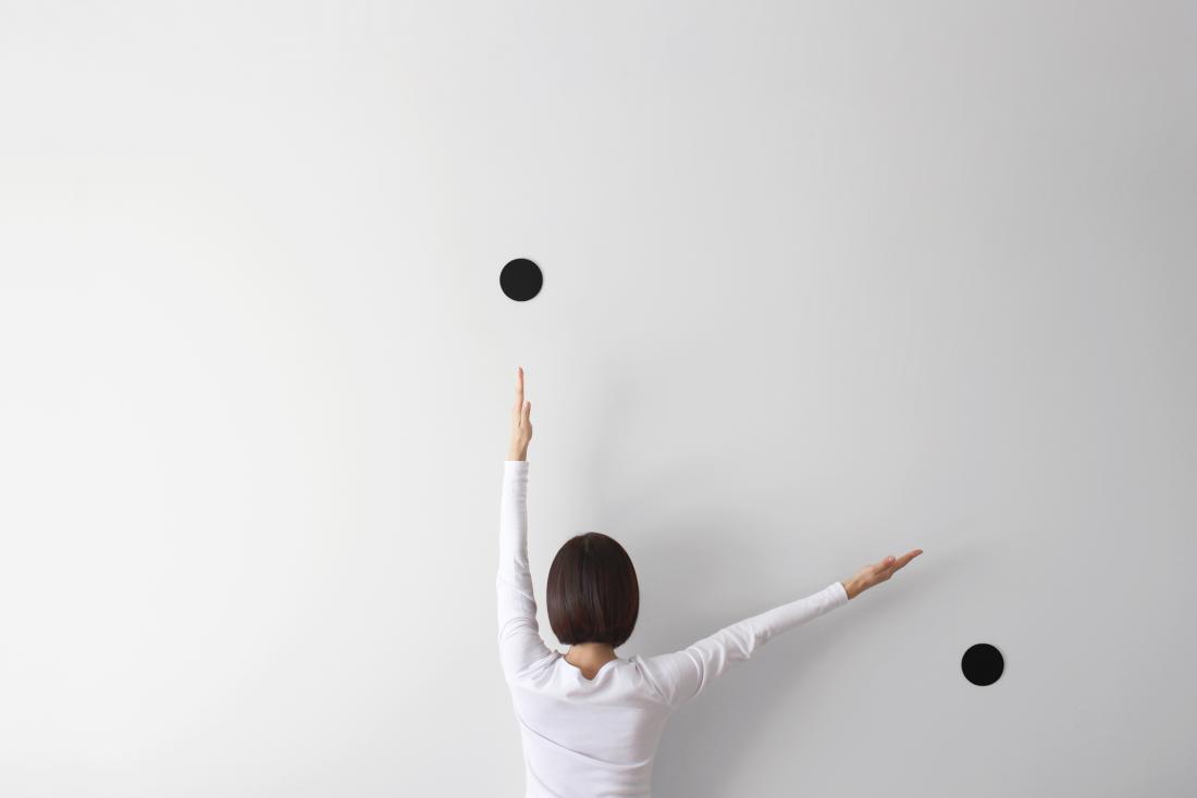 person facing wall simulating a clock