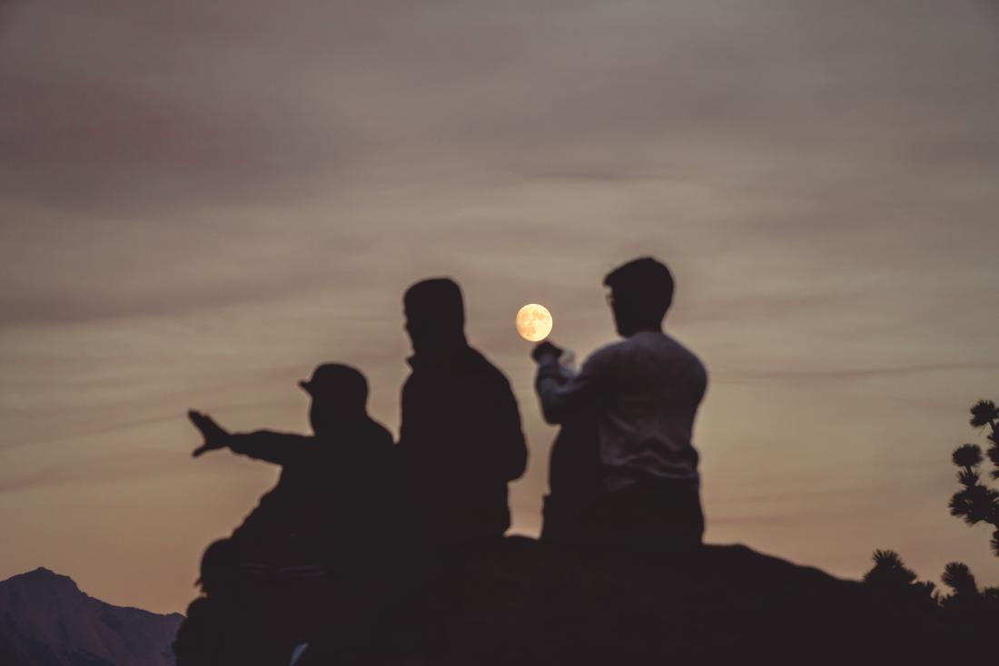 three silhouettes in the moonlight