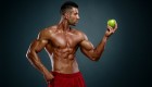 Bodybuilder holding apple