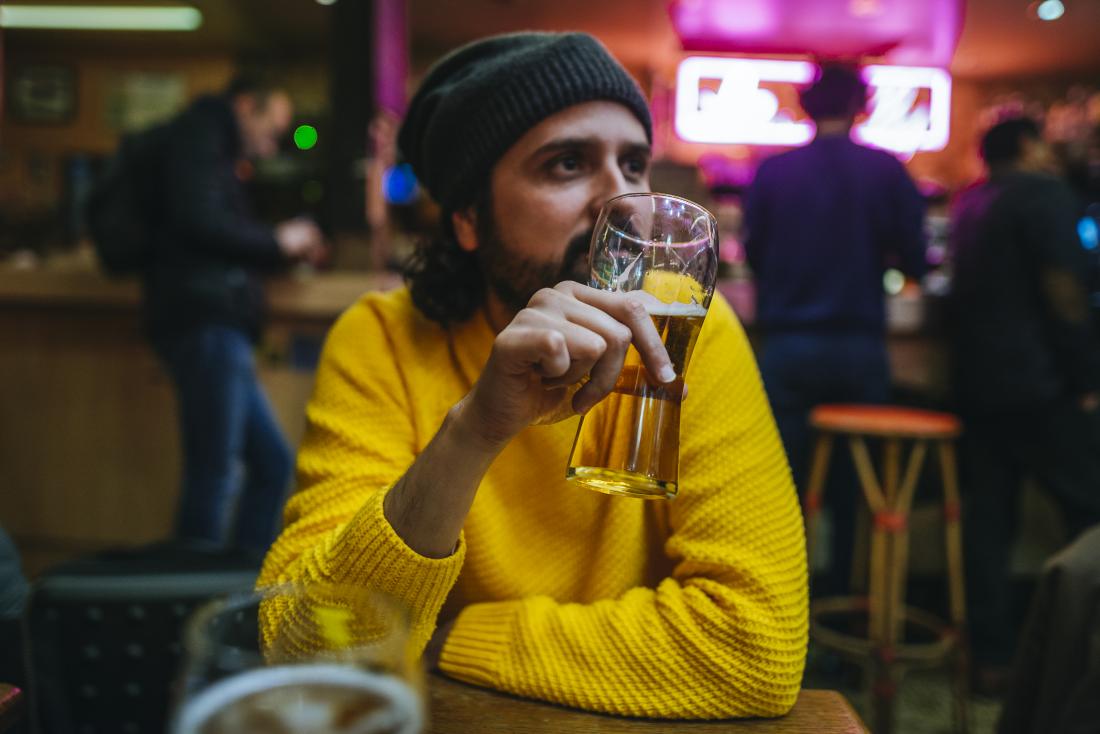Man drinking beer or alcohol in bar