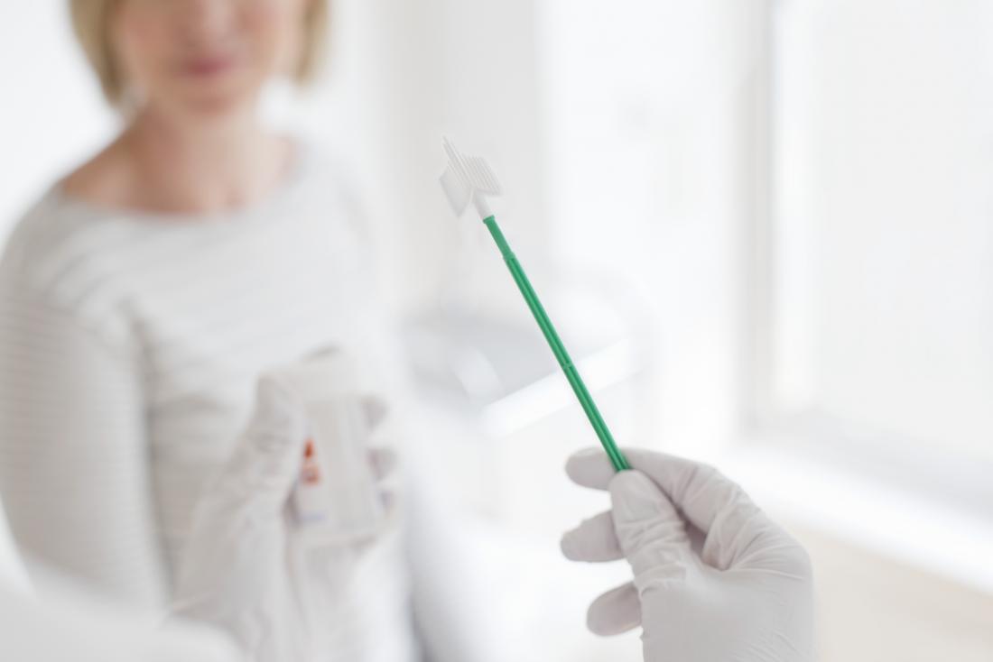 Doctor showing patient equipment for pap or smear test