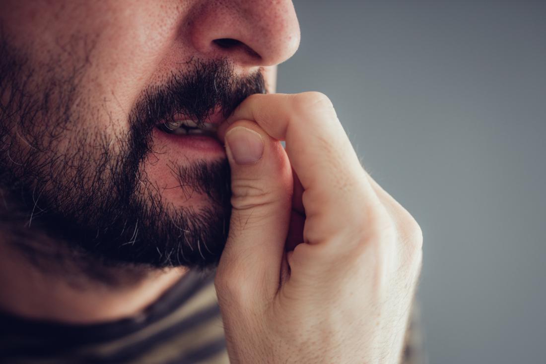 Anxious or nervous person chewing or biting skin and nails.
