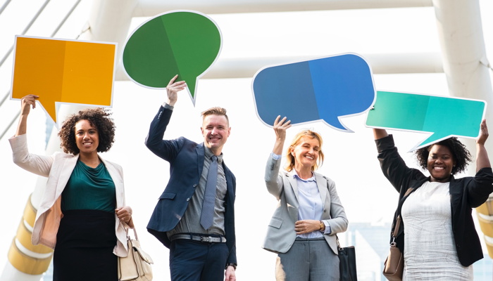 our people holding bubble chat boards - Photo by rawpixel on Unsplash