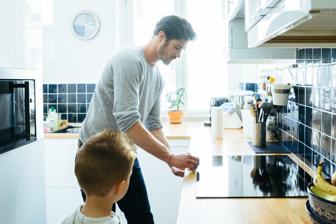 man cleaning dust in kitchen