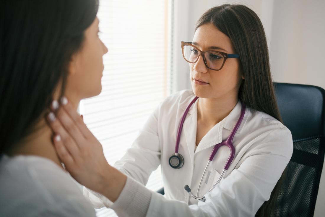 Doctor feeling for a reactive lymph node